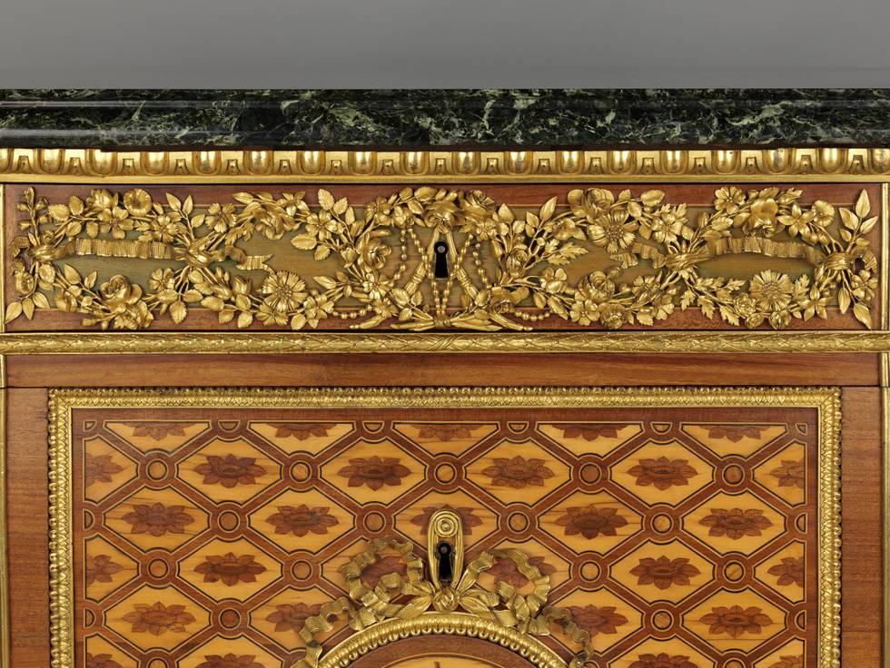 A detail of the gilt-bronze floral frieze mount on a marquetry chest of drawers