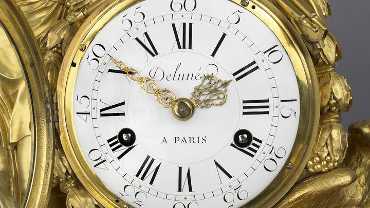 A detail of the dial of a gilt-bronze mantel clock