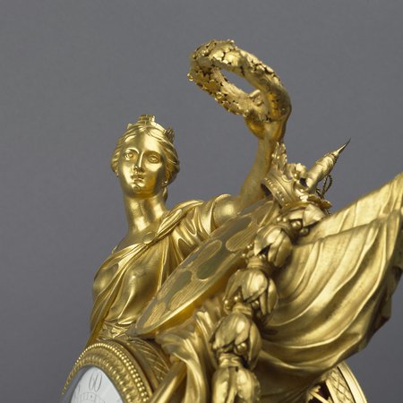 A detail of a gilt-bronze mantel clock
