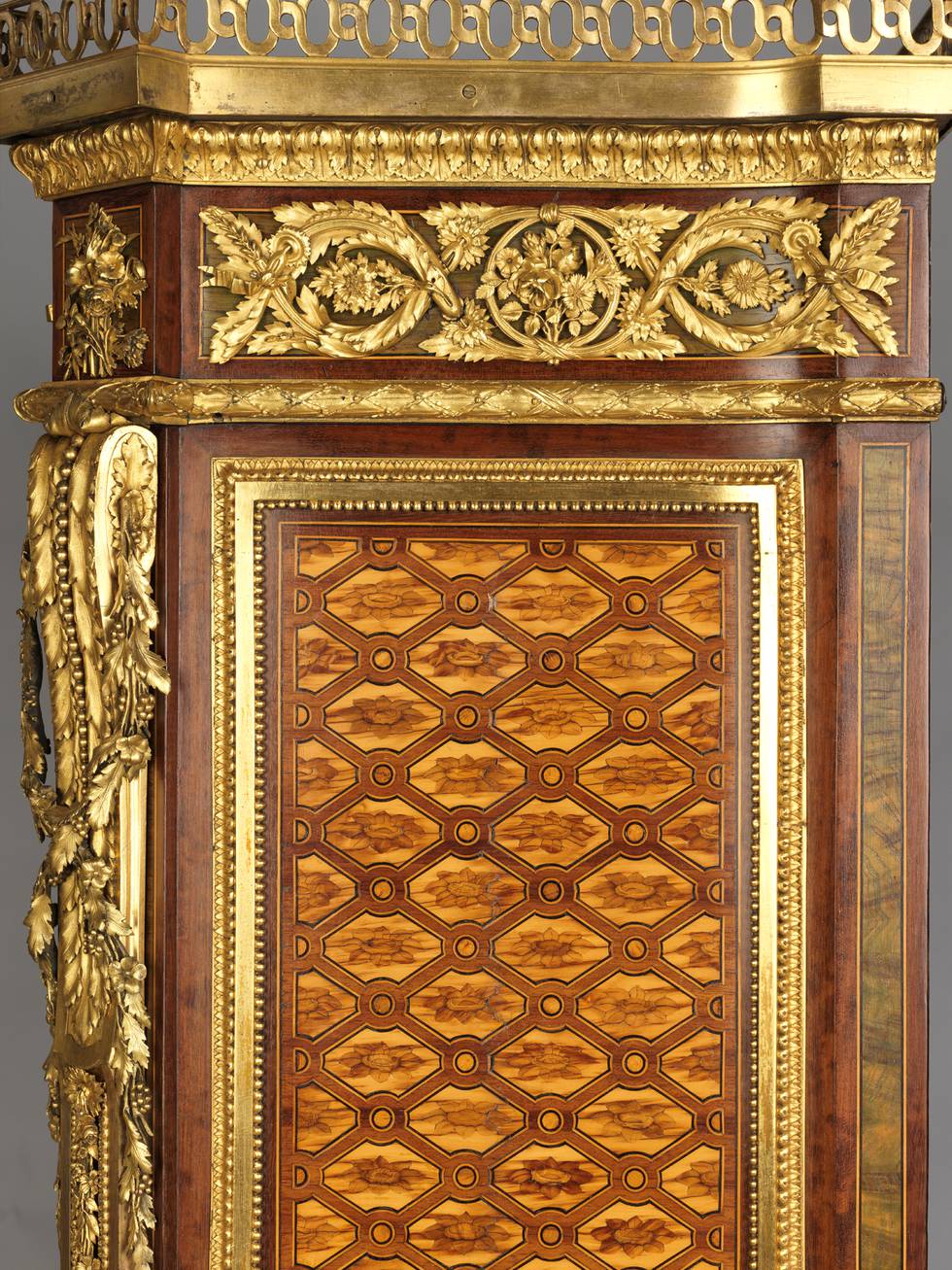 A detail of the side of a marquetry fall-front desk