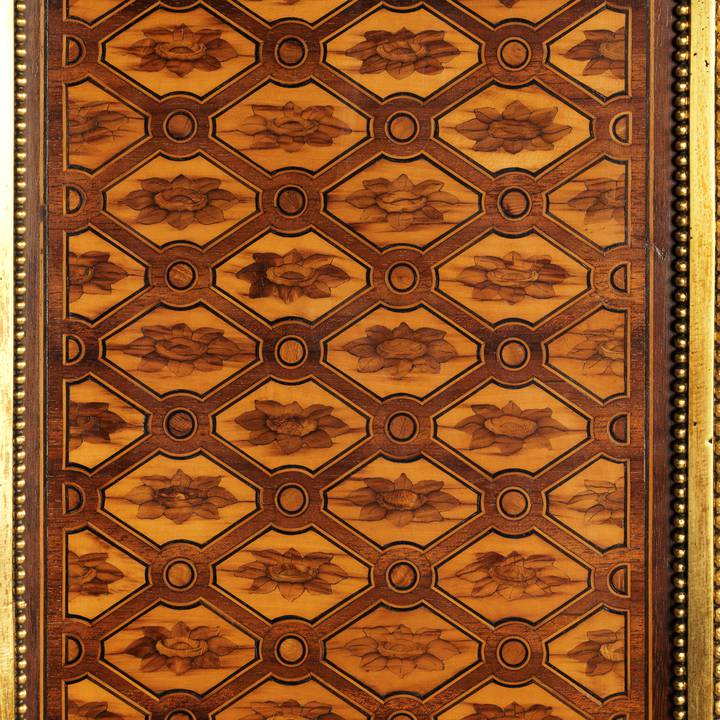 Detail of wooden paneling with a repeated flower pattern