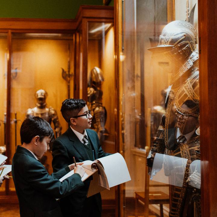 Teacher and student looking at arms and armour in the galleries